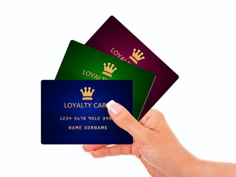 hand holding loyalty cards isolated over white